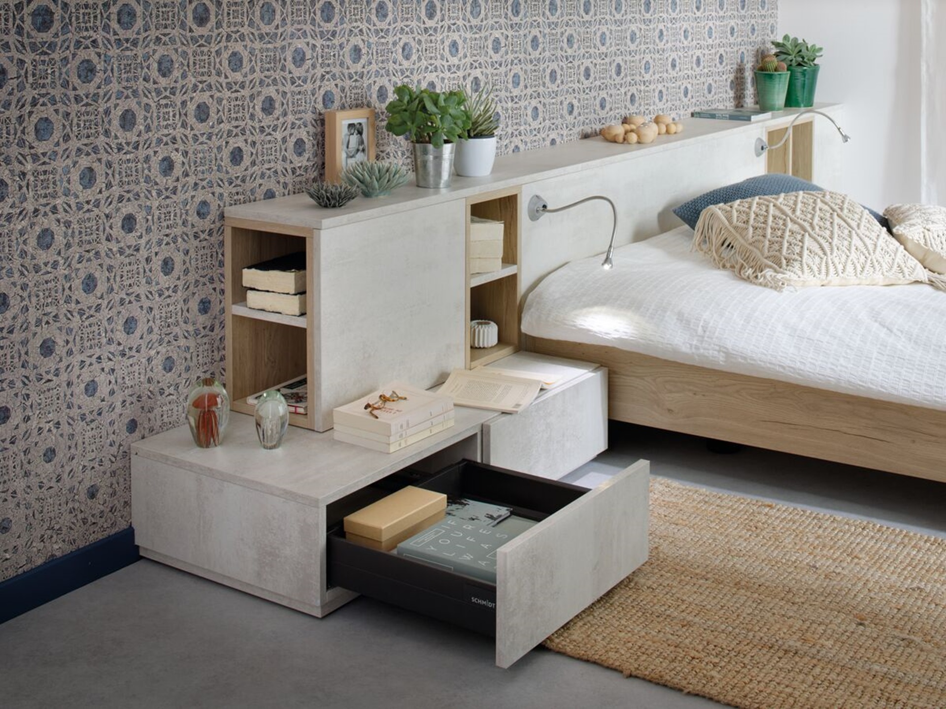 Vue de détail d'ambiance du rangement Arcos melaminé en coloris beige clair Harvey, cadrée sur les tiroirs autour du lit dans une chambre